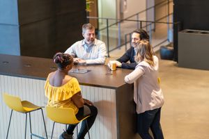 Ann, Jeff, Pablo, and Kimberley catching up over a coffee - our thing - in Calgary's Ampersand building lobby.